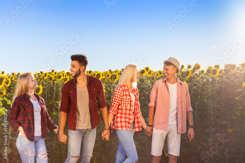 People group friends outdoor countryside sunflowers field blue sky two couple happy smile, summer sunny day