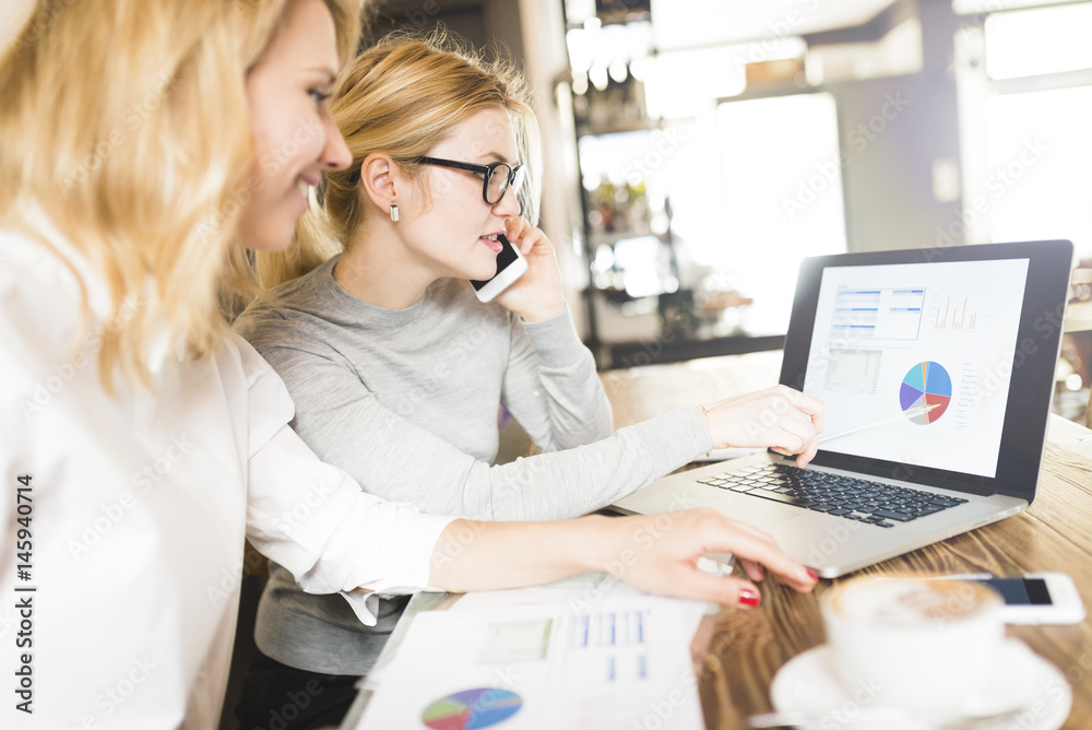 Two businesswomen working together on project Two businesswomen working together on project