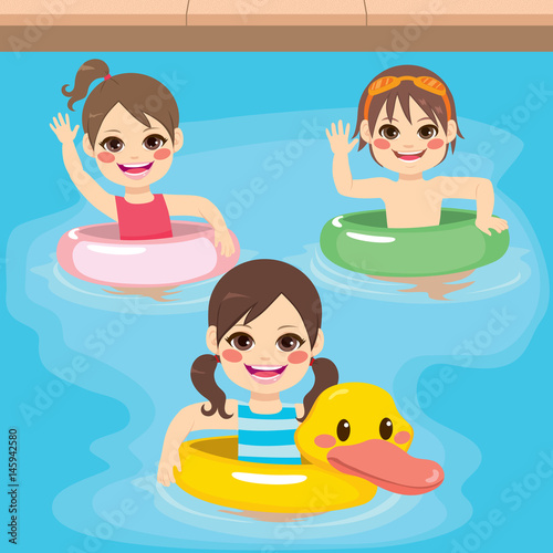 Three cute little children with inflatable ring playing on swimming pool