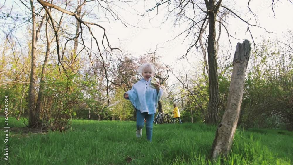 Happy cute little girl running on the grass in the park. Happiness. Happy cute little girl running on the grass in the park. Happiness.
