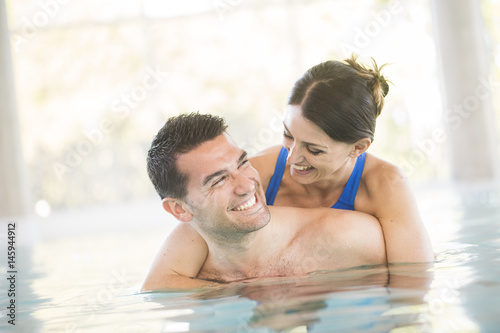 Cheerful couple in a swimming pool