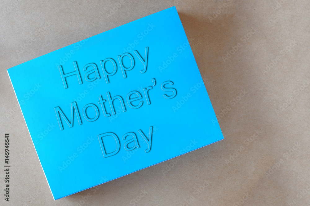 Happy mothers day words on blue book, holiday and event concept and mothers day idea Happy mothers day words on blue book, holiday and event concept and mothers day idea