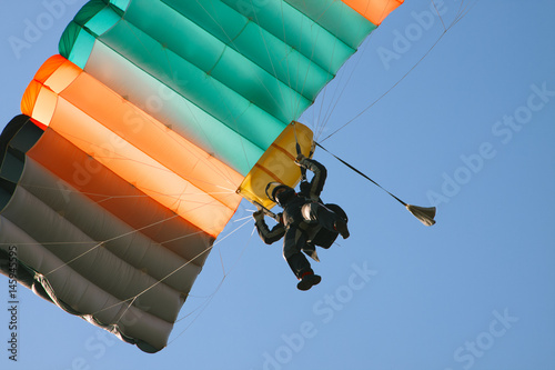 View from the bottom up to the landing a skydiver.