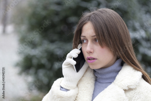 Young woman phoning in the park