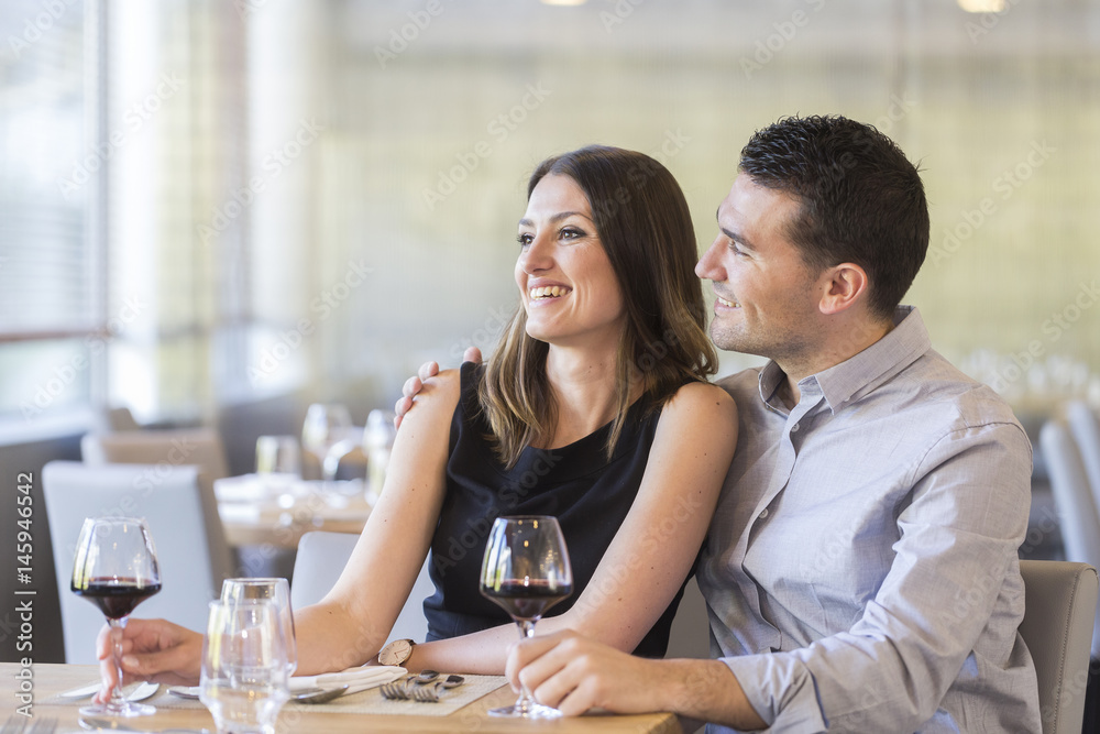 happy young couple in a restaurant
