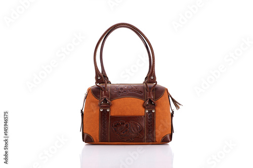 Leather ladies bag on a white background. Beautiful, fashionable, accessory, isolated. Interesting design, the texture of the skin. Comfortable handle.