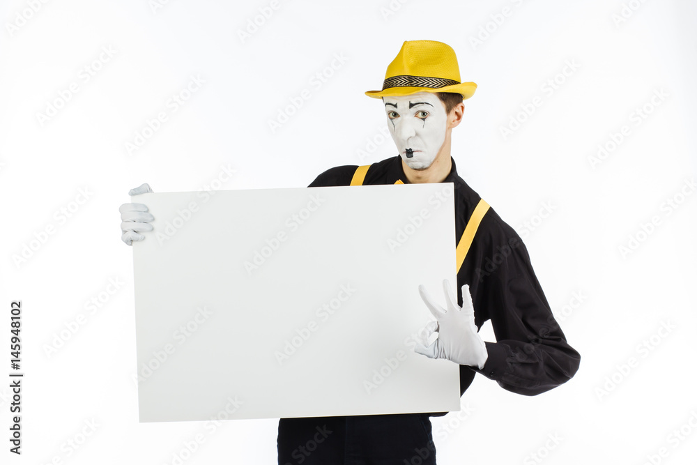 MIME, actor, young man holding white panel with space for text. MIME, actor, young man holding white panel with space for text.
