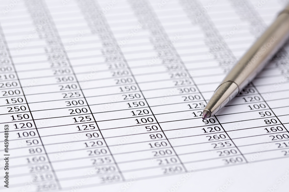Close up a silver pen on financial accounting and marketing table analysis Close up a silver pen on financial accounting and marketing table analysis