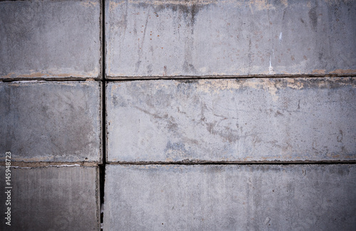 Close-up part of wall of gray concrete blocks.