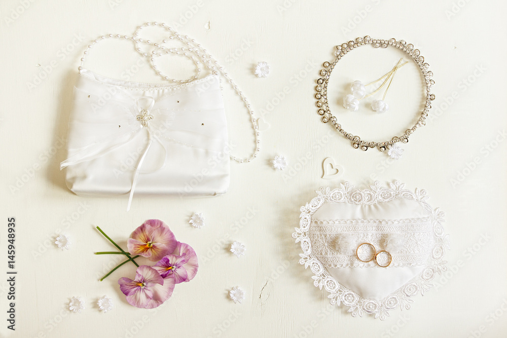 Wedding background. Bride accessories: rings, handbag, boutonniere, necklace. Wedding background. Bride accessories: rings, handbag, boutonniere, necklace.
