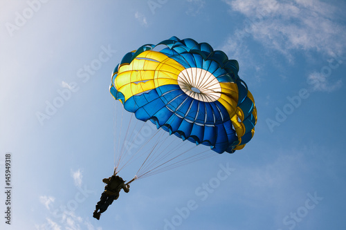 Parachute on background blue sky.