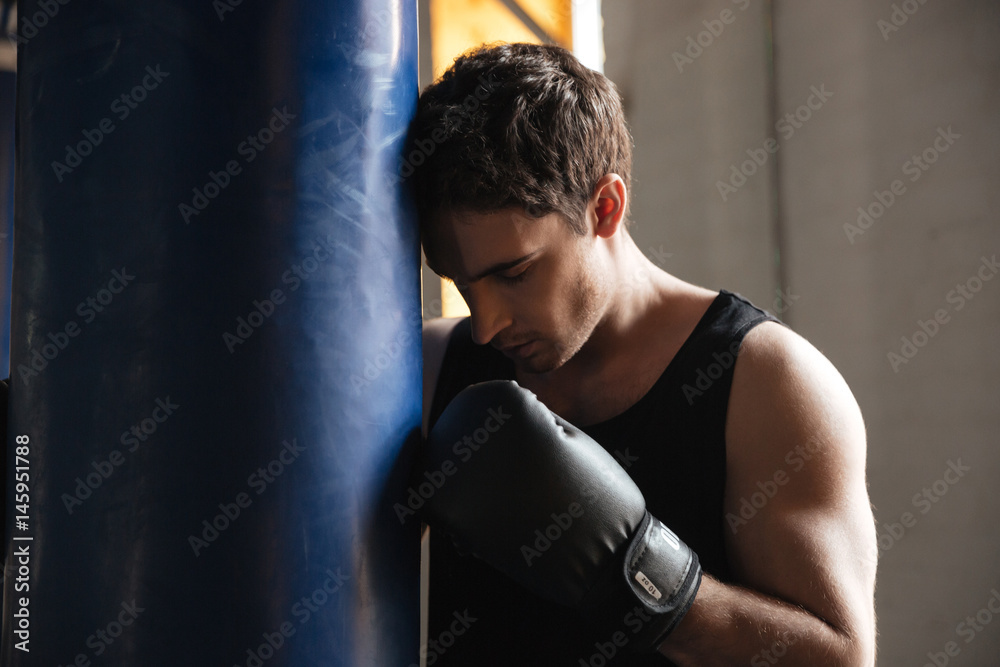 Pensive sportsman boxer thinking about training