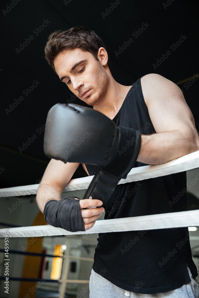Thoughtful boxer wearing gloves Thoughtful boxer wearing gloves