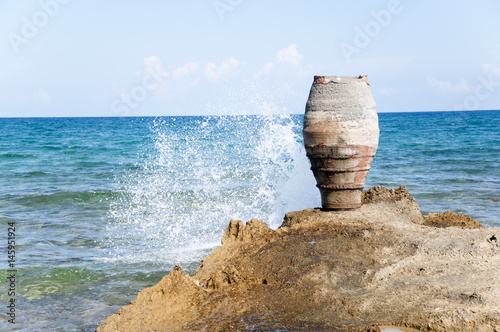 Amphora on the rocky beach