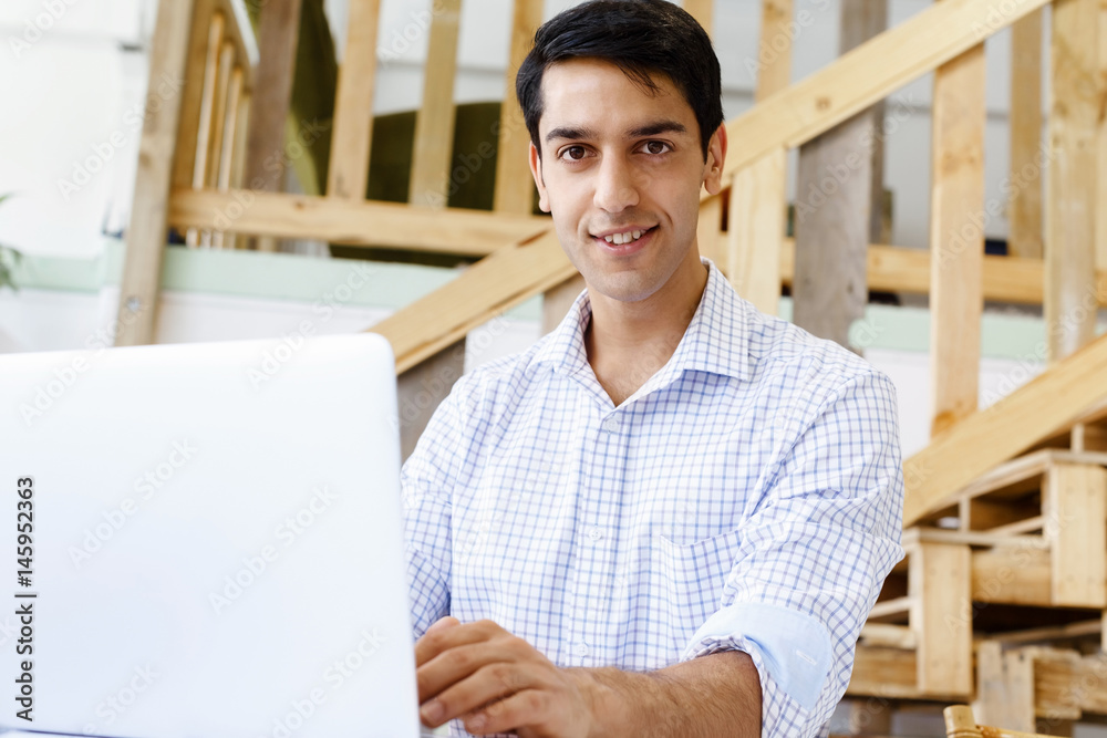 Portrait of young man in office Portrait of young man in office