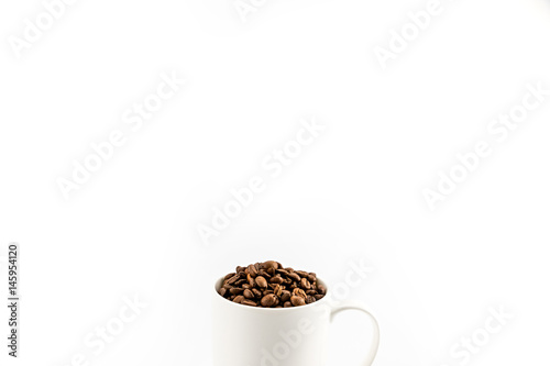 Foto roasted coffee beans in coffee mug  isolated on white