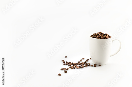 roasted coffee beans in coffee mug  isolated on white