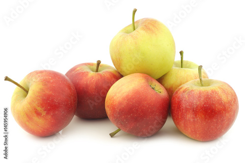 fresh red and yellow apples on a white background