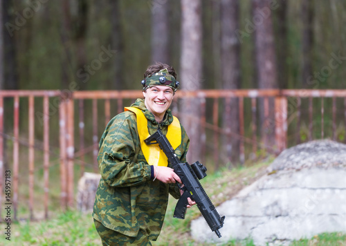 The smiling sniper with the paintball gun.