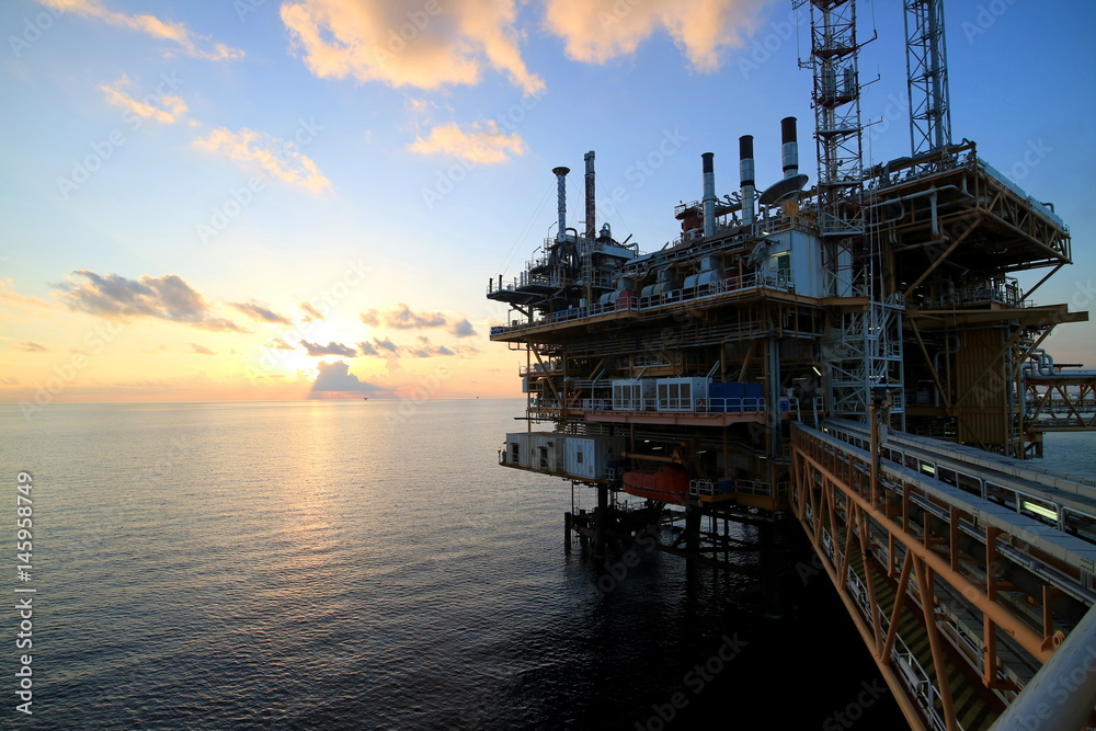 Offshore construction platform for production oil and gas with sunset sky Offshore construction platform for production oil and gas with sunset sky
