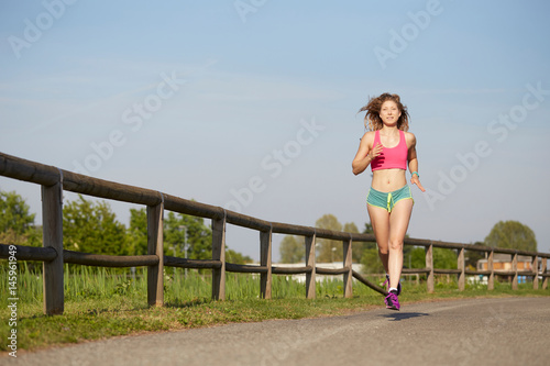 fit woman running at park in summer © Stocked House Studio