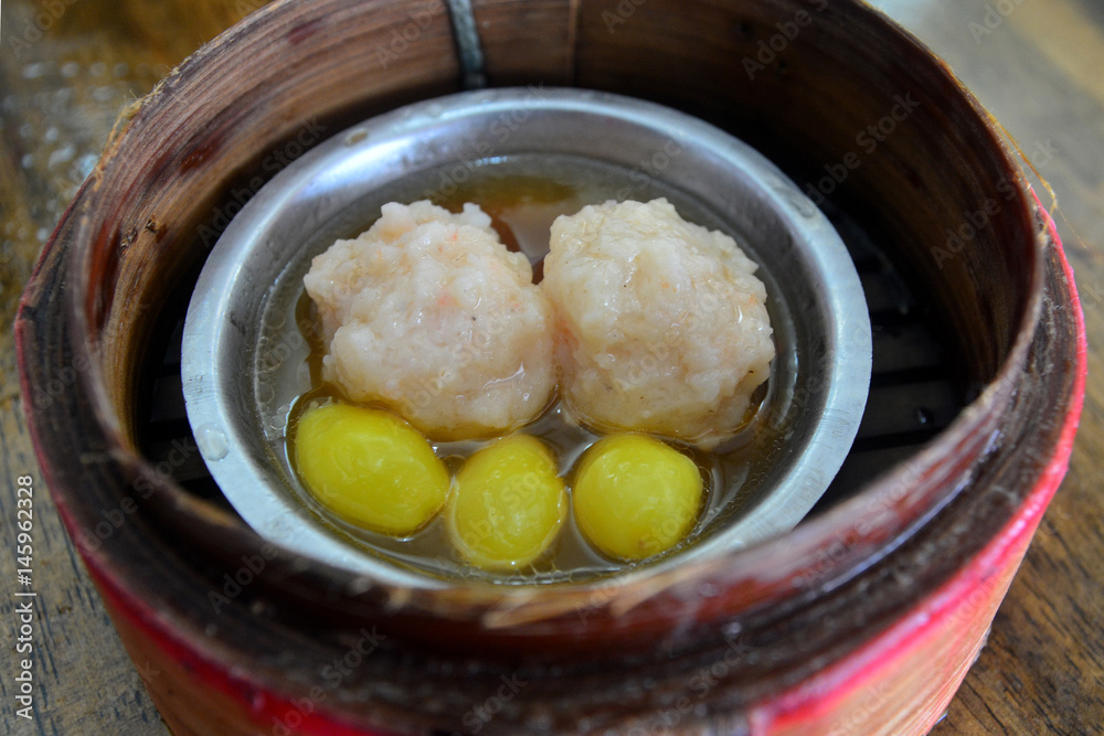 Chinese pork dumplings in a bamboo steamer Chinese pork dumplings in a bamboo steamer