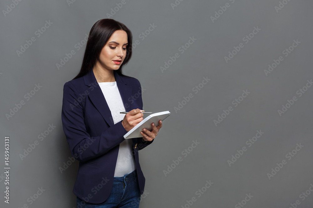 Business woman checking schedule in notepad Business woman checking schedule in notepad