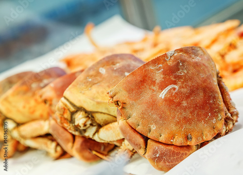 half of fresh crab on ice for sale in a fish market