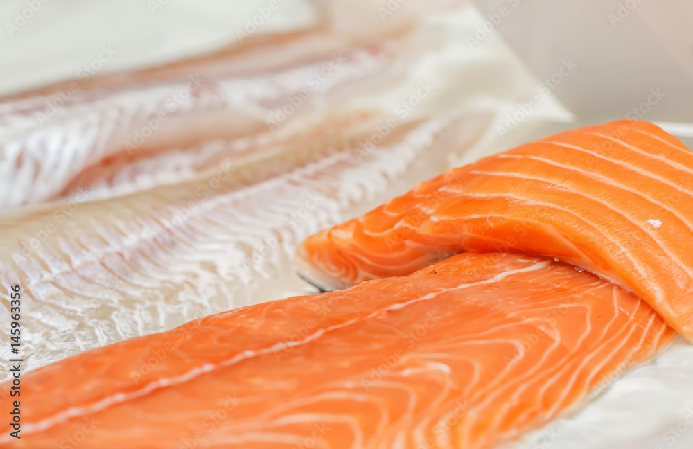 fresh uncooked salmon fillet on showcase of seafood market. fresh uncooked salmon fillet on showcase of seafood market.