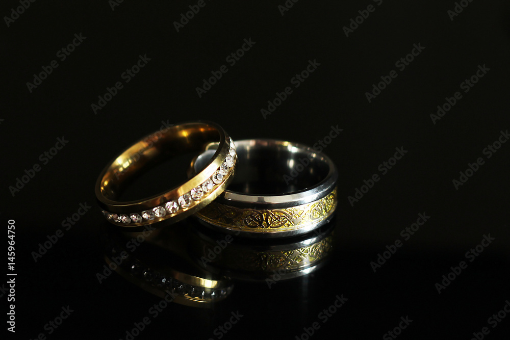 Wedding rings on a black glossy background Wedding rings on a black glossy background