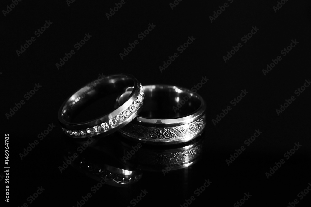 Wedding rings on a black glossy background Wedding rings on a black glossy background
