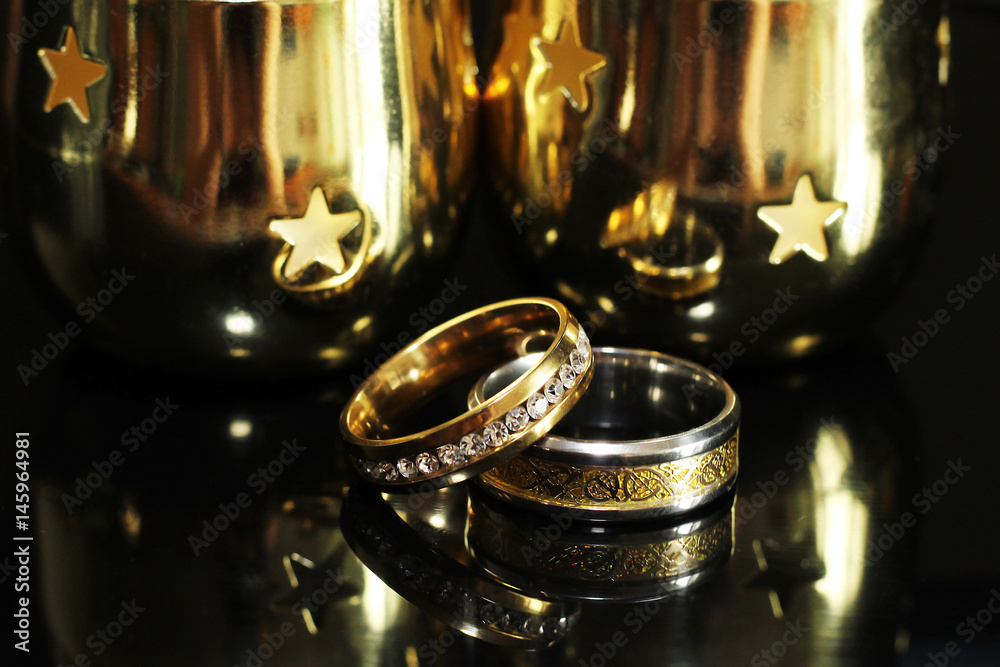 Wedding rings on a black glossy background