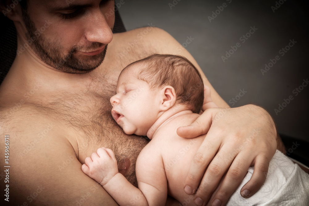 newborn child and father