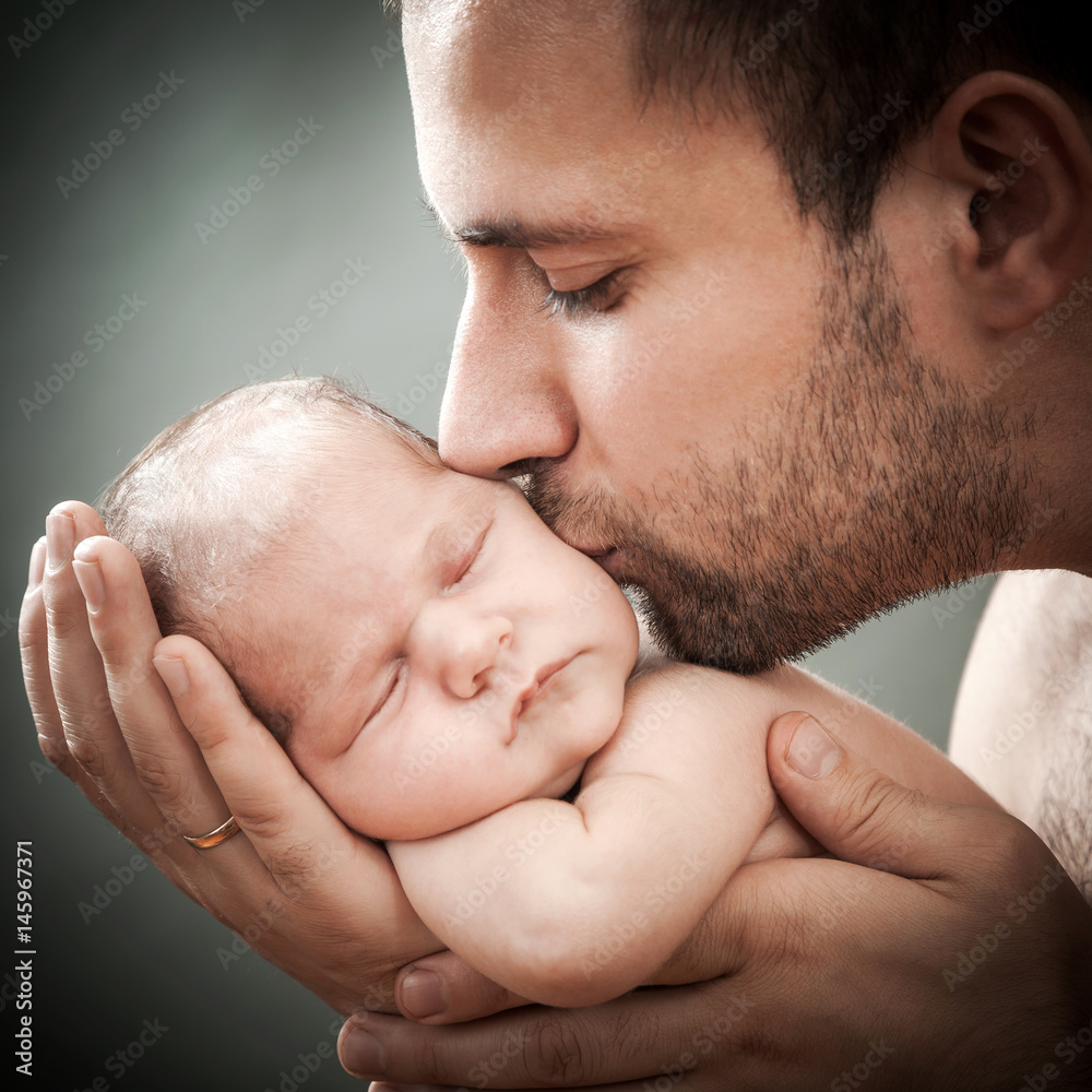 newborn child and father