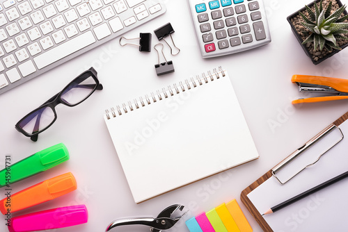 White office desk table with school accessories with office supplies. Top view with copy space