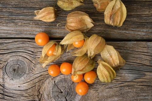 yellow organic physalis on a wooden board photo