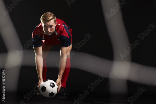Professional Soccer Player Placing Ball For Penalty Kick