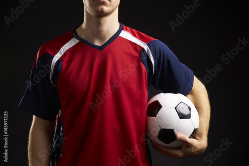 Close Up Of Professional Soccer Player With Ball In Studio