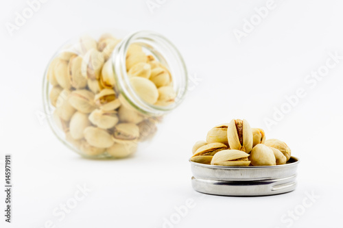 Isolated roasted pistachios nuts on a white background