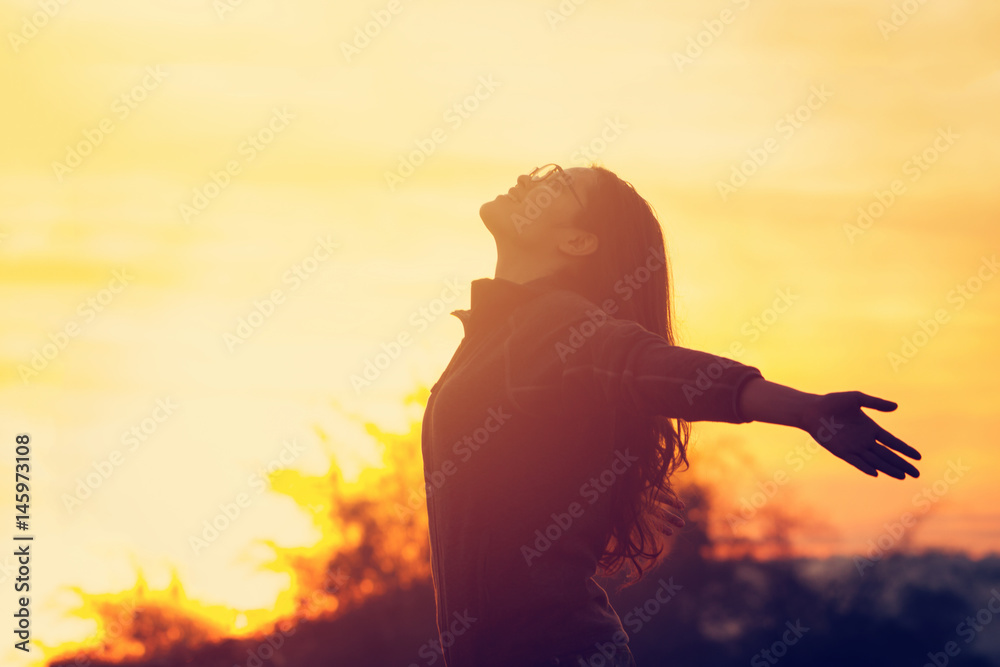 Young woman relaxing in summer sunset sky outdoor.