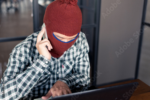 electronic crime concept. hacker is calling while using computer.