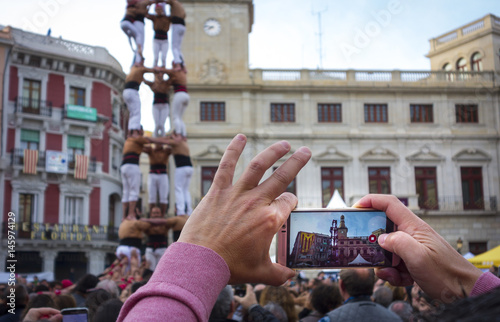 Hand held smartphone taking a picture of Castells Performance photo