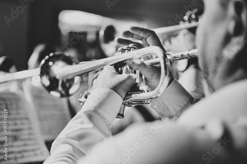 Trumpet in the hands of a musician in the band photo