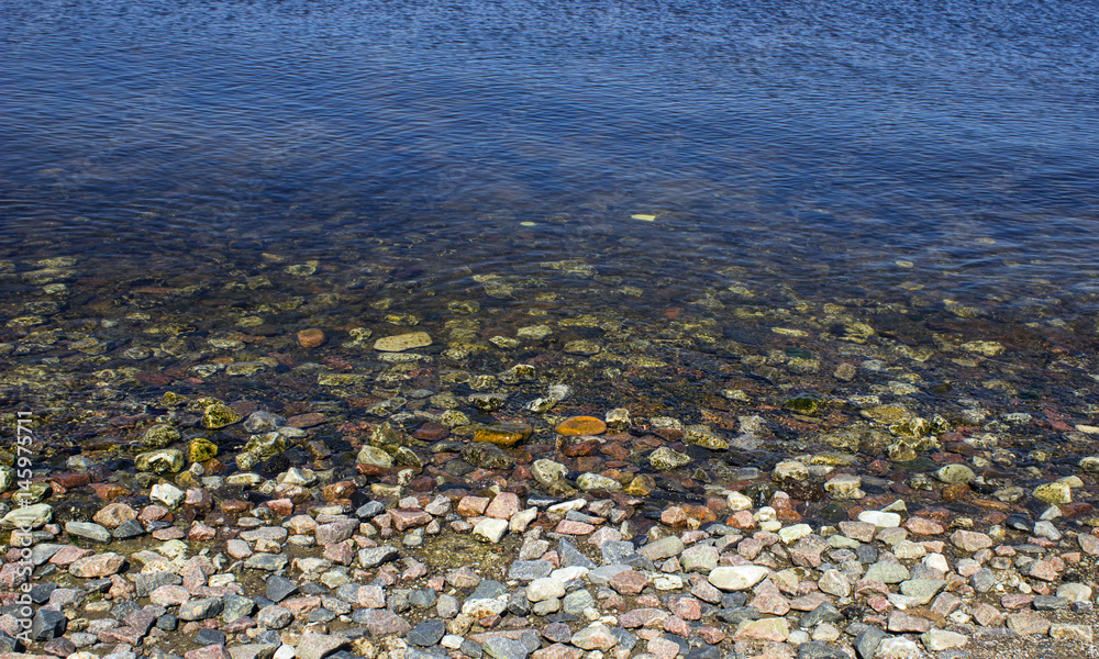 Dry and wet stones on the shore Dry and wet stones on the shore