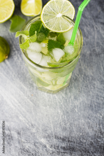 Mojito cocktail with lime and mint on a black background