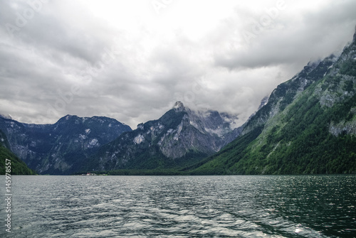 Low clouds over forest and mountains on bank of lake Koenigssee  Bavaria  Germany