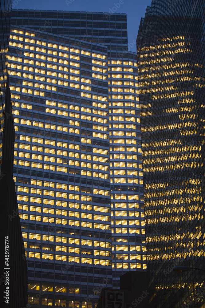 Fototapeta premium Skyscrapers windows at nigth.