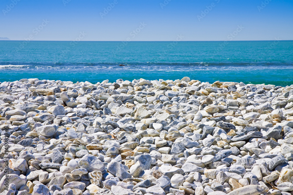 White and gray stones softly rounded against a blue sky