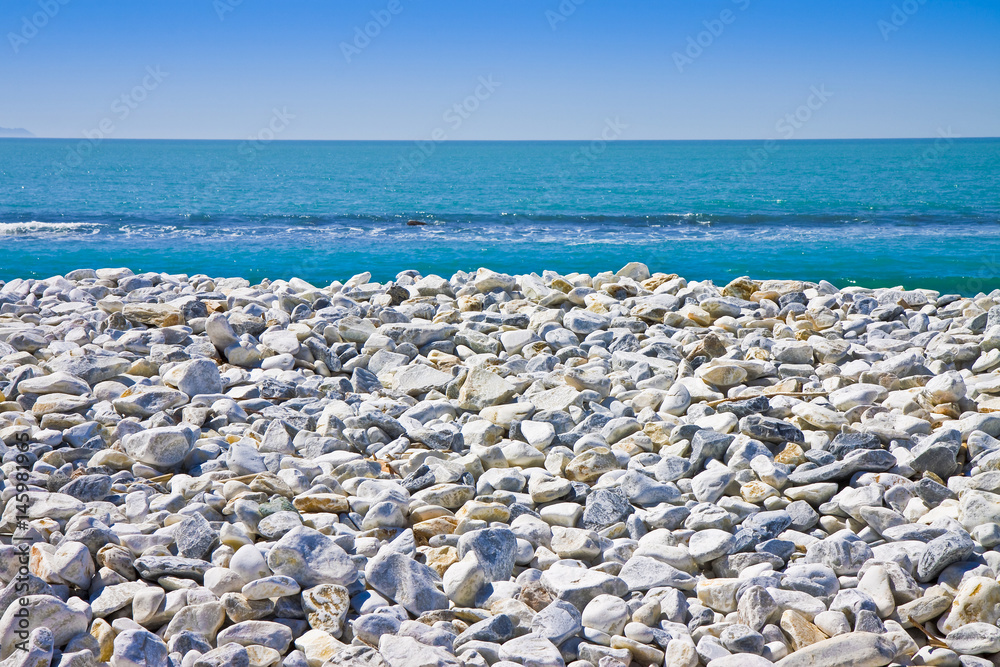White and gray stones softly rounded against a blue sky White and gray stones softly rounded against a blue sky