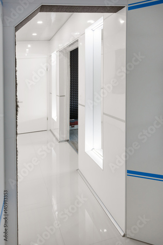 Modern home hallway interior. White plactic panels and tiles. Futuristic interior concept design. Space ship at home.